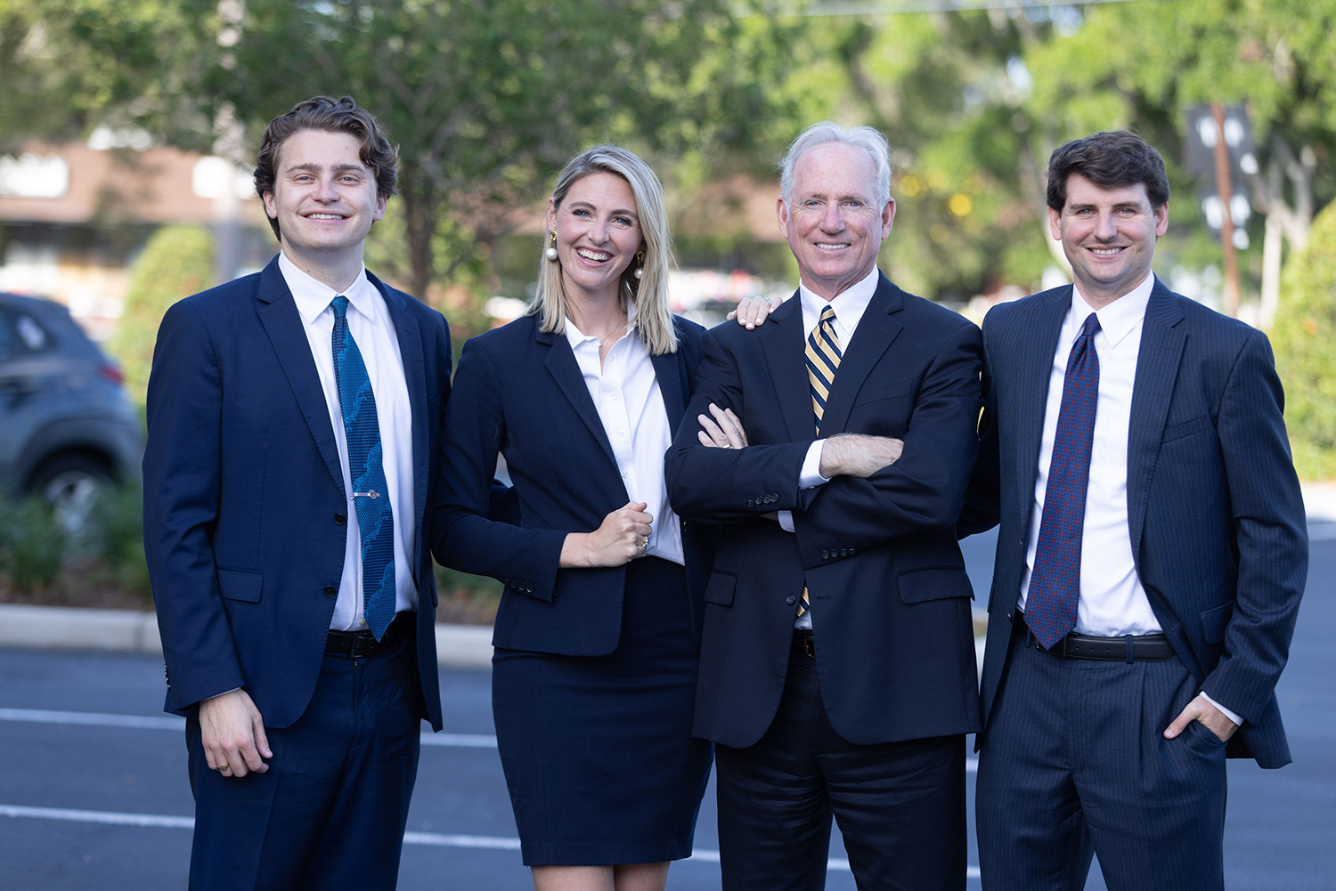 Ingram Injury Law attorneys Timothy M. Ingram, Jr., Timothy M. Ingram, Sr., Megan E. Ingram, & Mark L. Hilberath posing outside